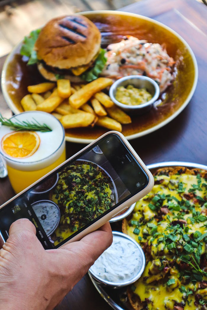 Food photography session capturing diverse delicious meals with a smartphone.